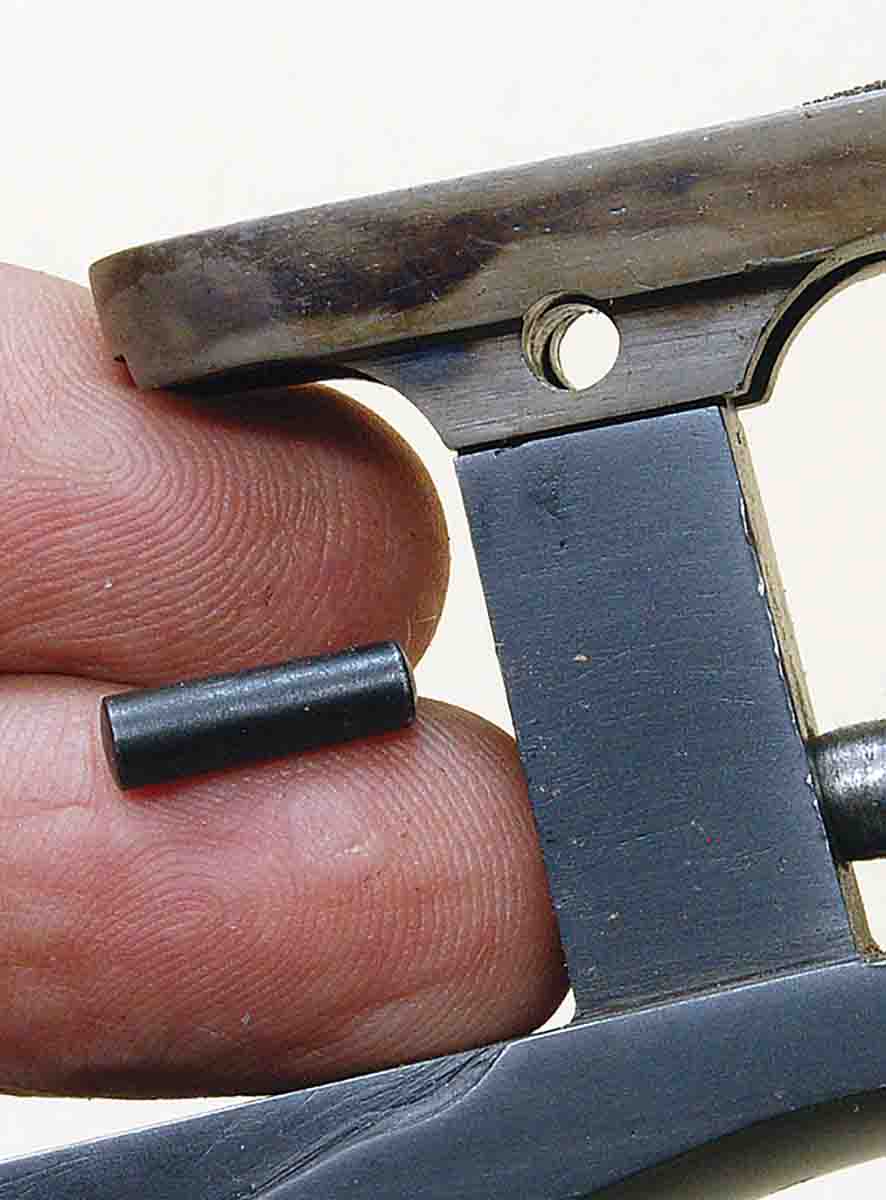 A tapered pin holds the trigger plate extension to the top tang of a custom Farquharson. A tapered pin is stronger in this application than a screw.